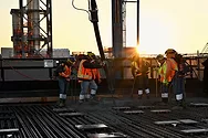 Workers pouring concrete.