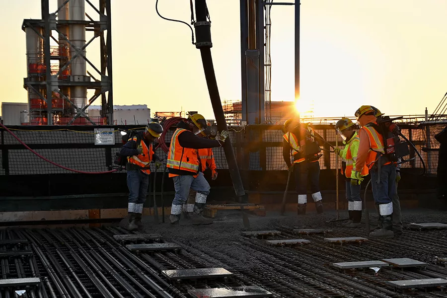 Workers pouring concrete.
