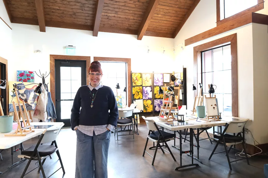 Woman stands in an art studio.