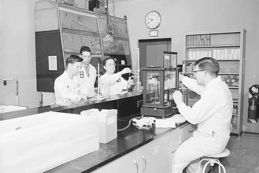 An old photo of people in a lab.