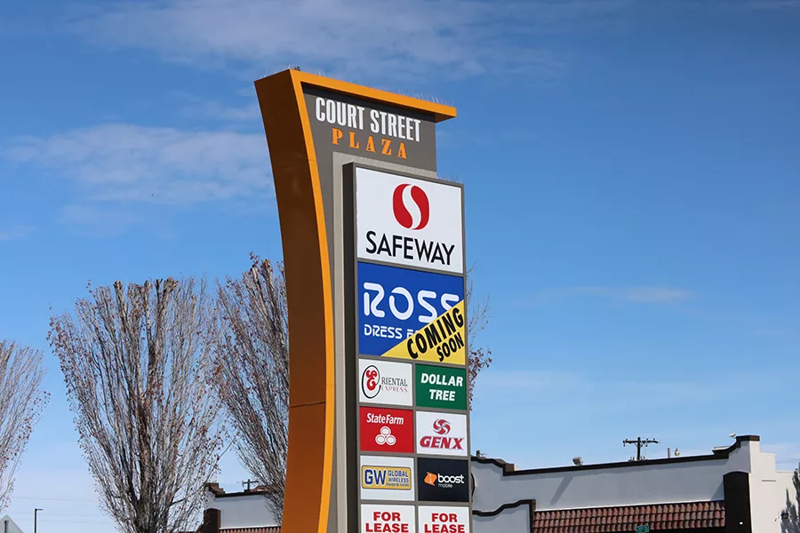 A sign showing multiple business, including Ross.