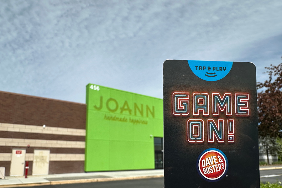 Exterior of Joann with a Dave & Busters play card in the foreground.