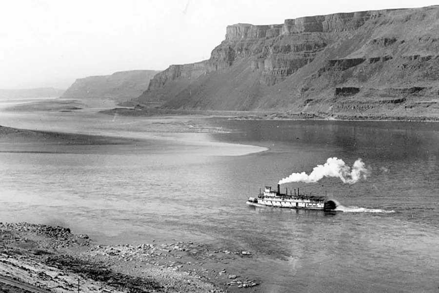 An old photo of a steamboat on the water.