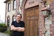 Man outside a brick building.
