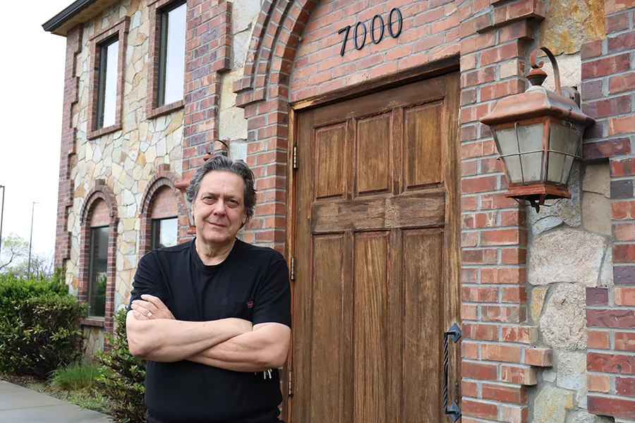 Man outside a brick building.