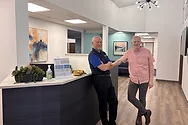 Two men standing in an office.