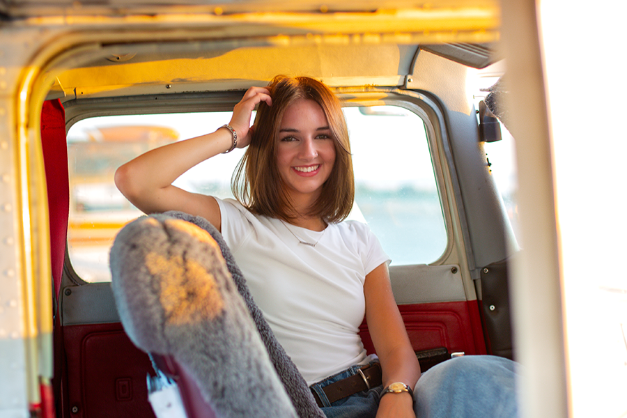 Woman sitting in a plane.