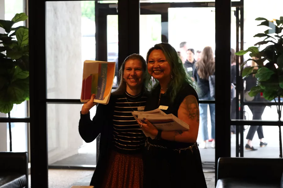 Two women with newspapers.