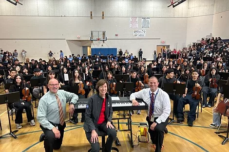 A class orchestra in a gym.