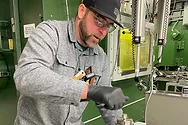 Man holding a capsule.