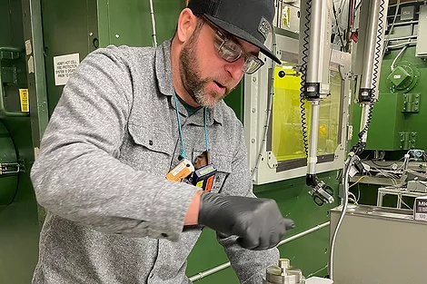 Man holding a capsule.