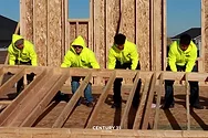 Students lifting a wall.