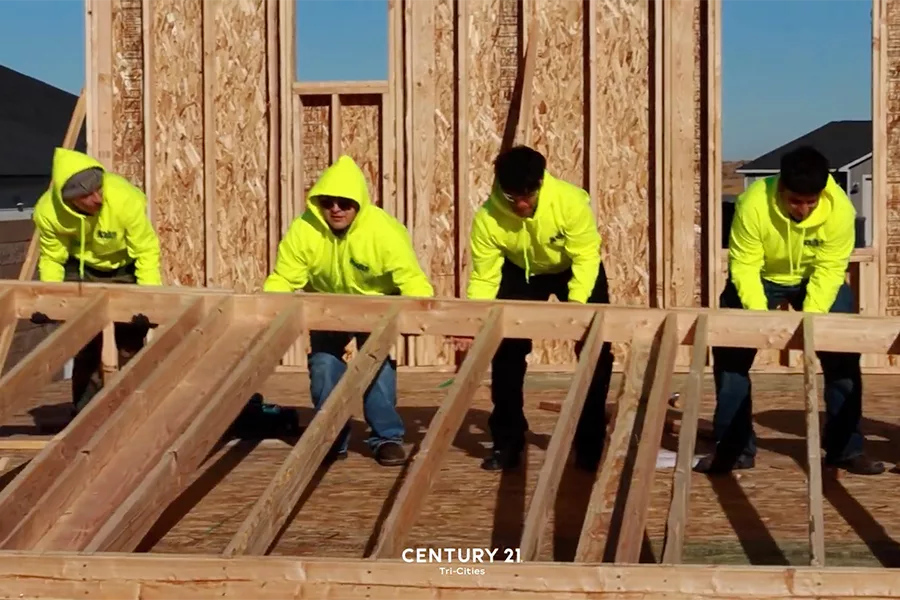 Students lifting a wall.