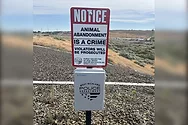 A sign stating that animal abandonment is a crime.
