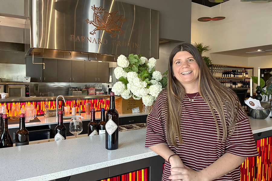 Woman leaning against bar.