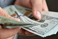 Someone counting $100 bills.