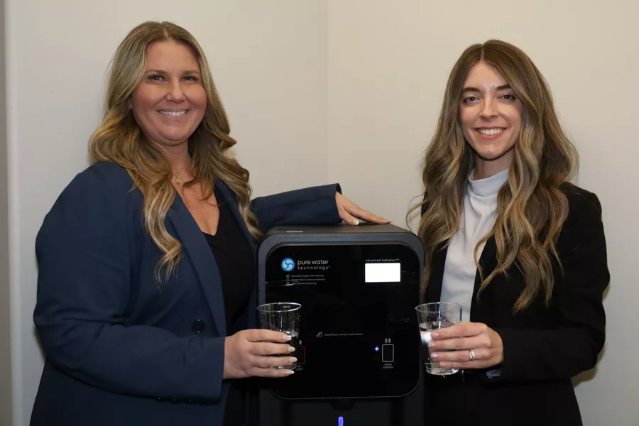 Two women with a water machine.