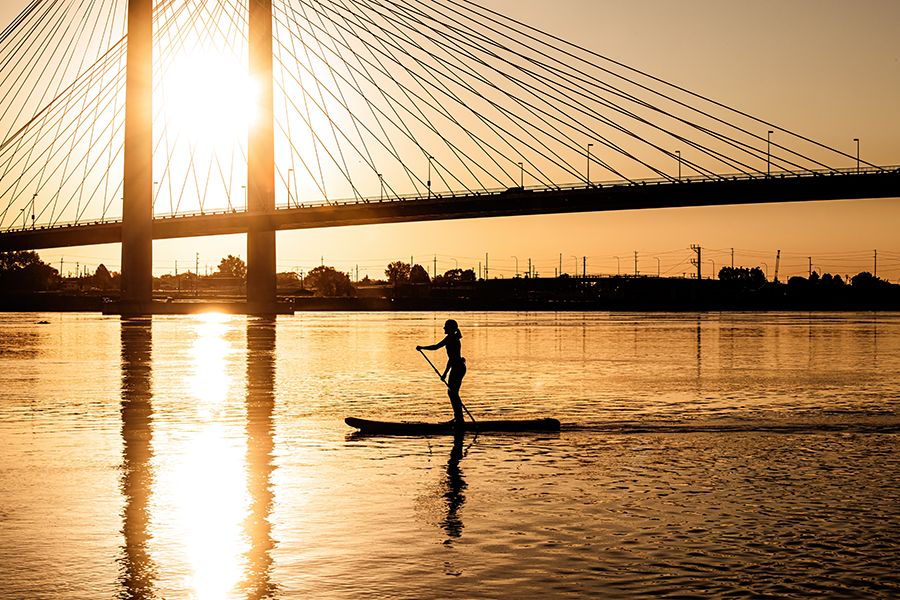 A woman paddle-boarding.