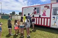 People lined-up near an ice cream truck.
