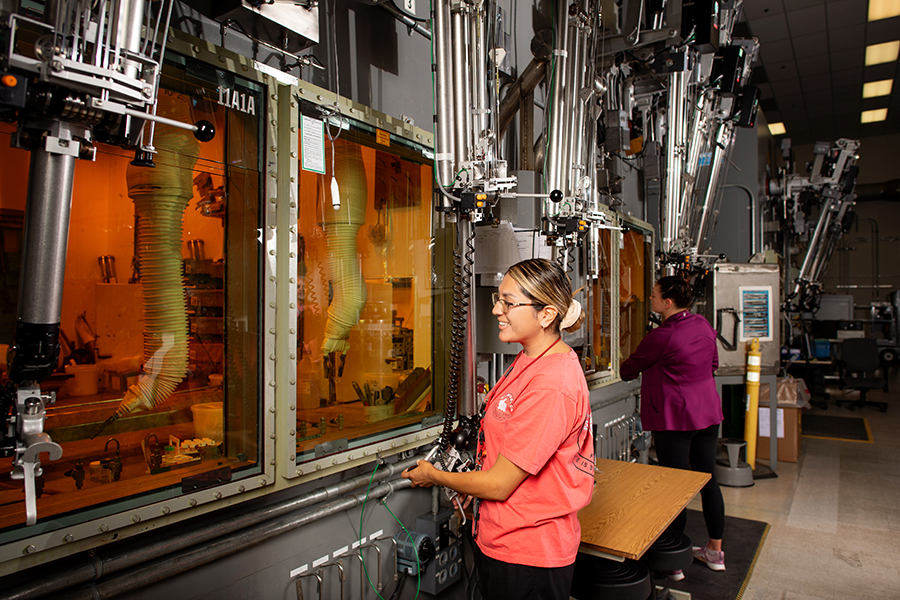 People looking inside hot cells.