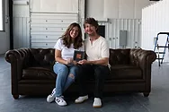A couple sitting on a couch.