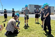 People standing around with hard hats.