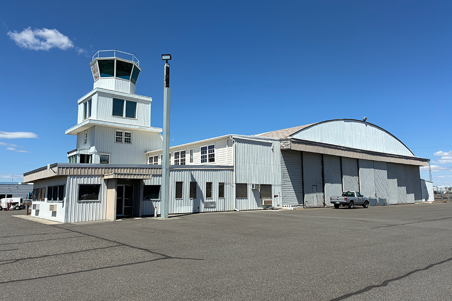 An old hangar with a control tower.
