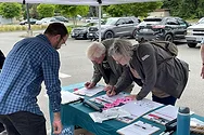 People signing petitions.