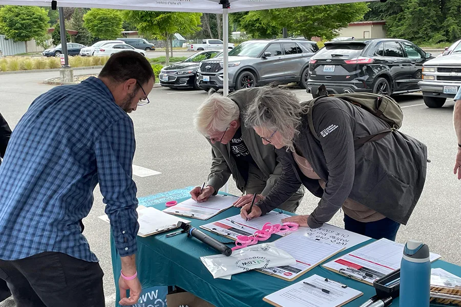 People signing petitions.