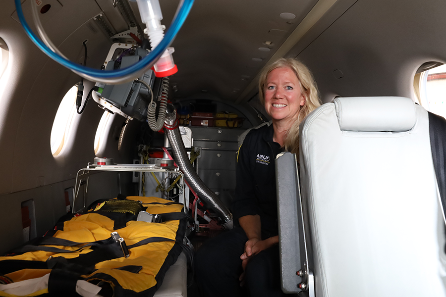 A photo of a woman in a plane.