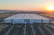An aerial view of an Amazon facility at sunset.