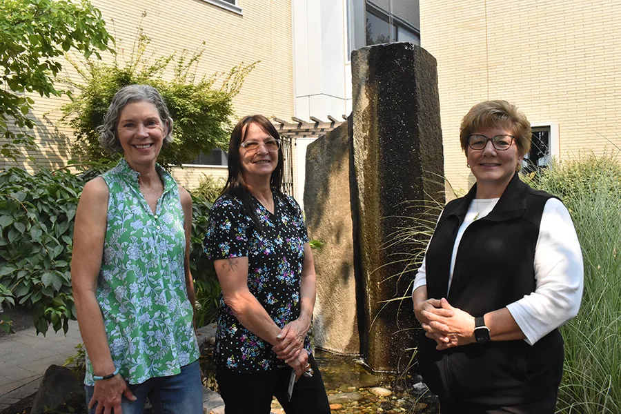 Three women in a garden.