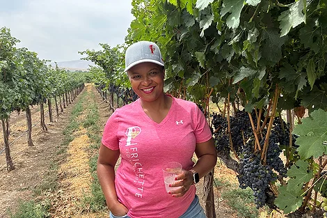 A woman in a vineyard.