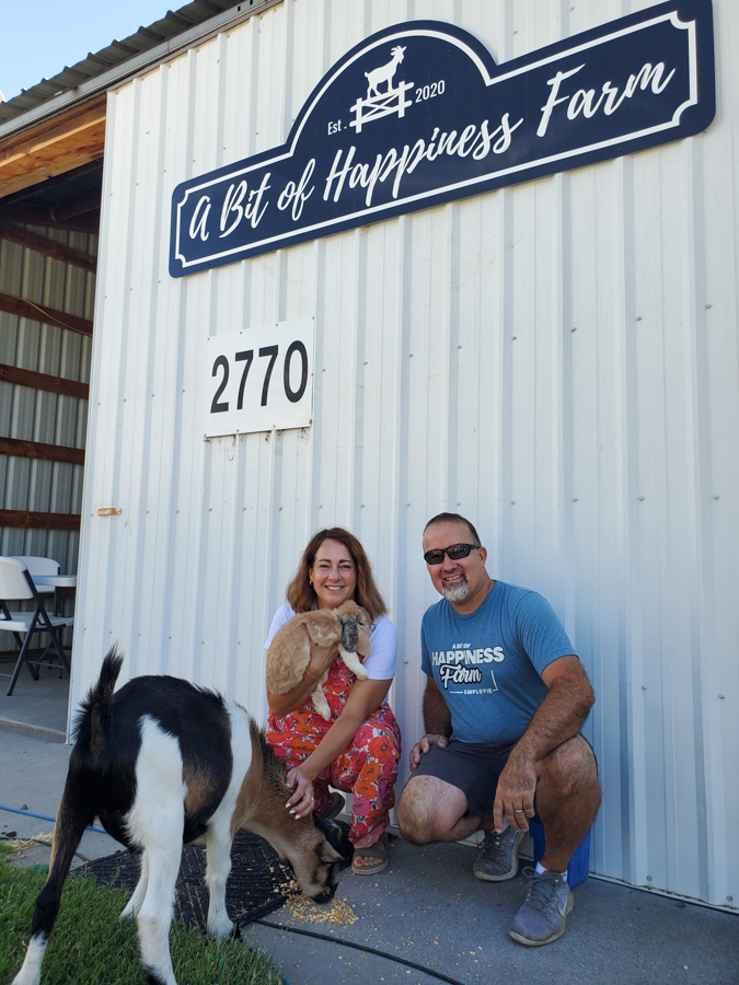 Two people and a goat.