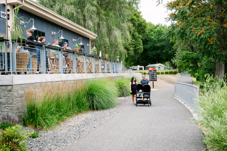 A couple walking along a path with a toddler