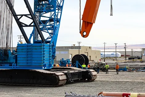 People next to a giant crane.