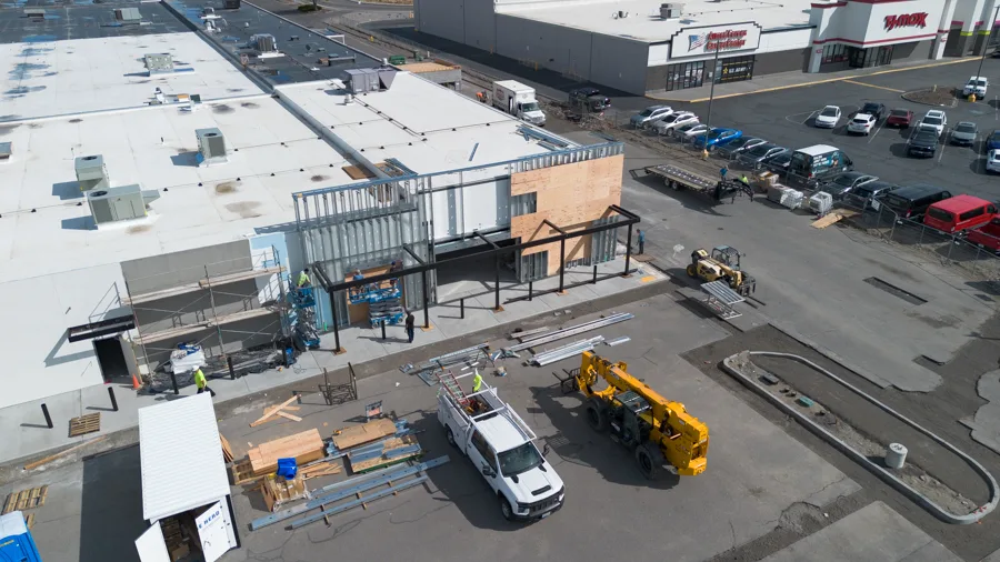 Aerial view of a corner building under construction.