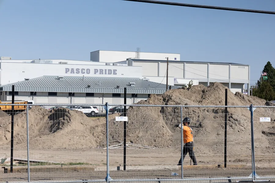 Exterior of Pasco High School with a big pile of dirt.