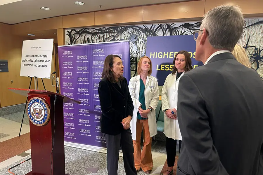 People standing around a podium.