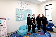 Four women in a daycare room.