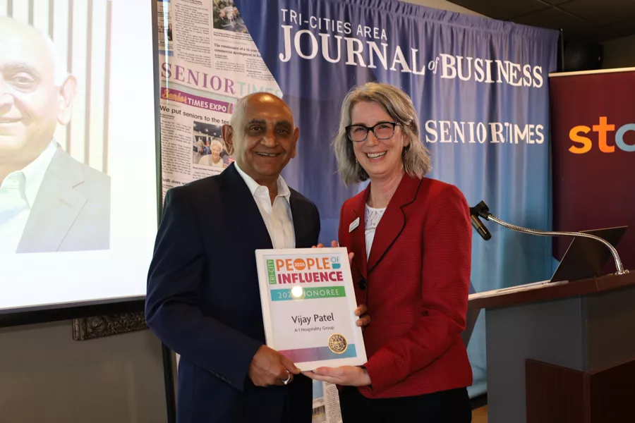 Two people on stage with an award.