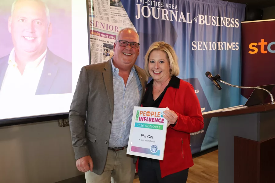 Two people on stage with an award.