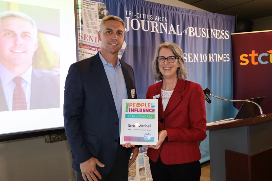 Two people on stage with an award.