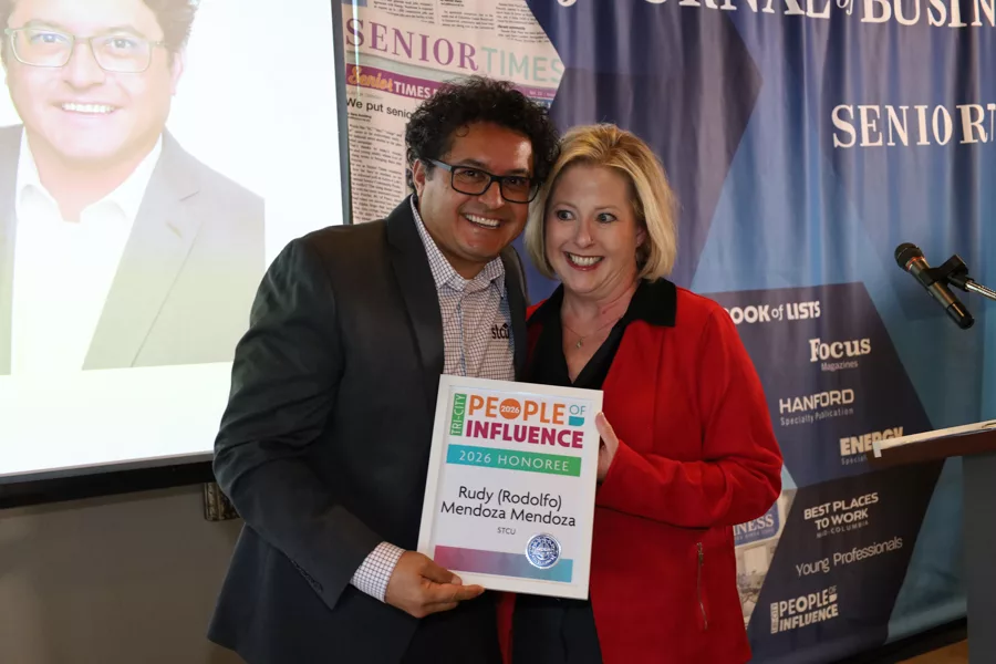 Two people on stage with an award.