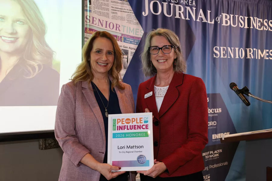Two people on stage with an award.