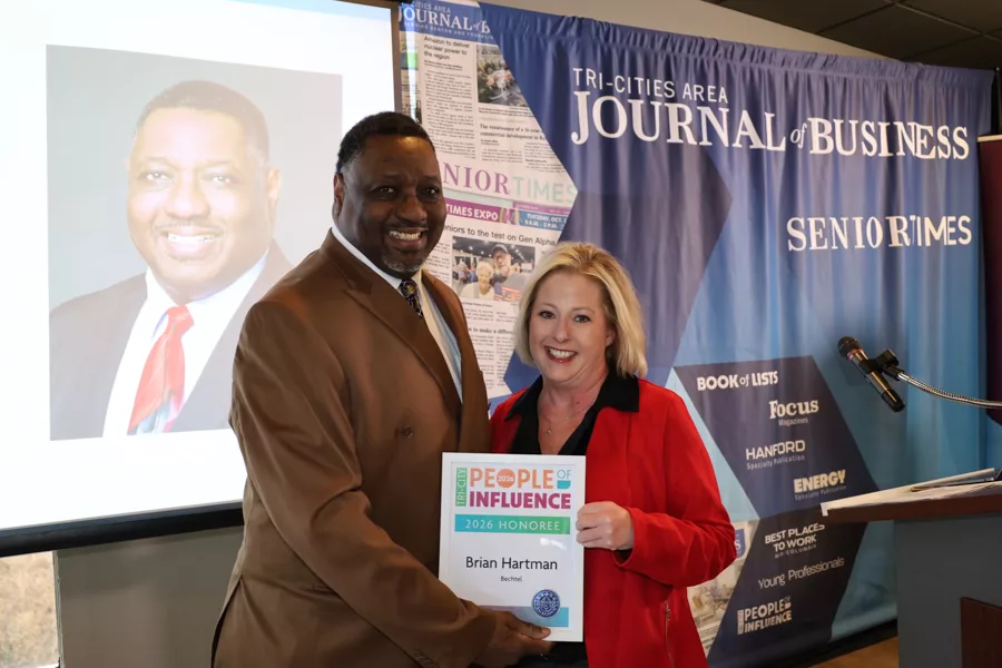 Two people on stage with an award.