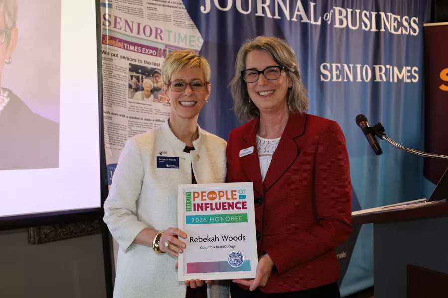 Two people on stage with an award.