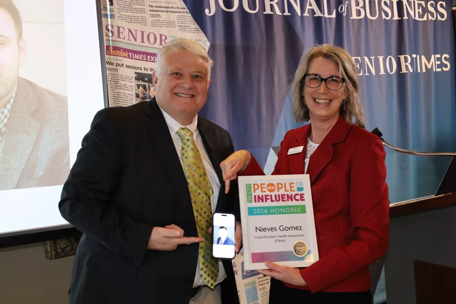Two people on stage with an award.