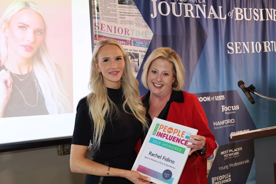 Two people on stage with an award.