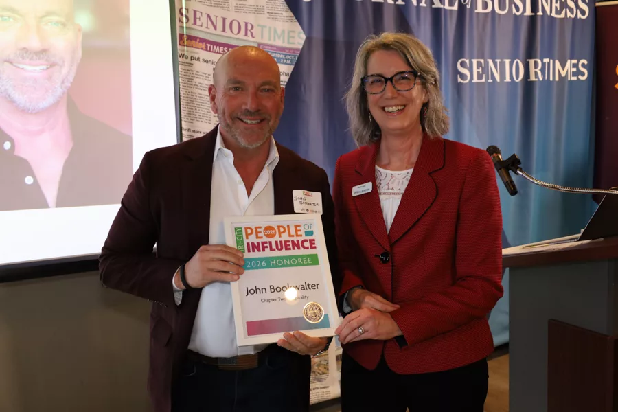 Two people on stage with an award.